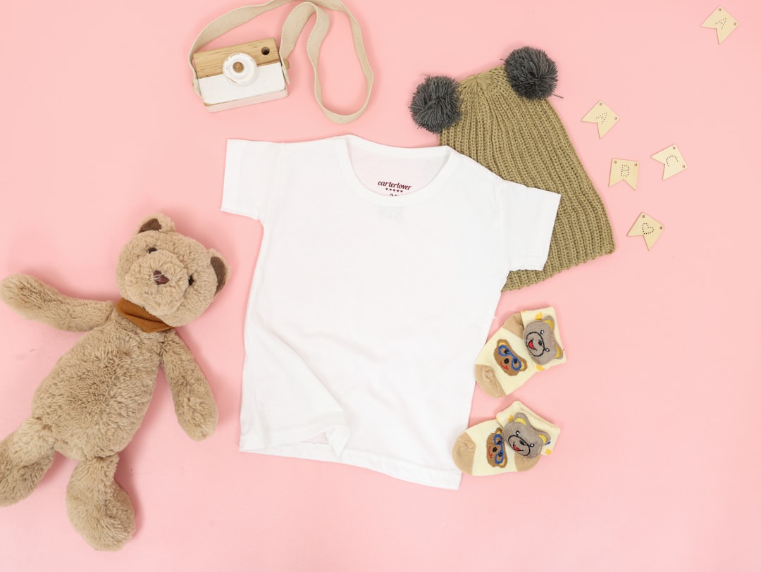 A collection of essential baby gear items including a diaper bag, stroller, baby monitor, and toys arranged in a cozy home setting.
