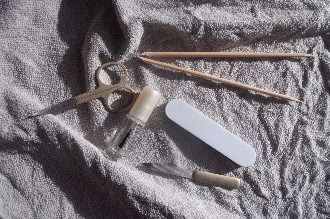 A collection of essential beauty tools arranged aesthetically, including facial rollers, aromatherapy oils, and dental care items, set against a calming background.