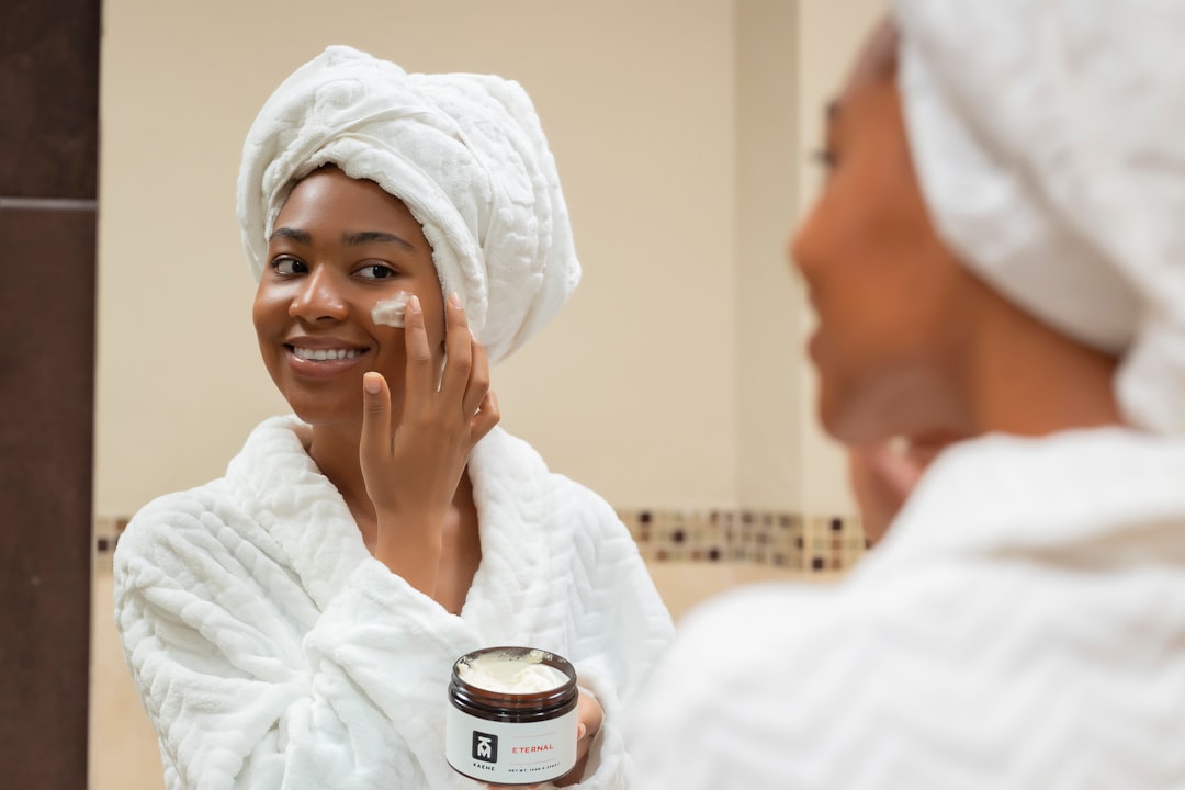 A serene bathroom counter with skin care products like cleansers, moisturizers, and serums arranged neatly, surrounded by natural elements like plants or soft towels.